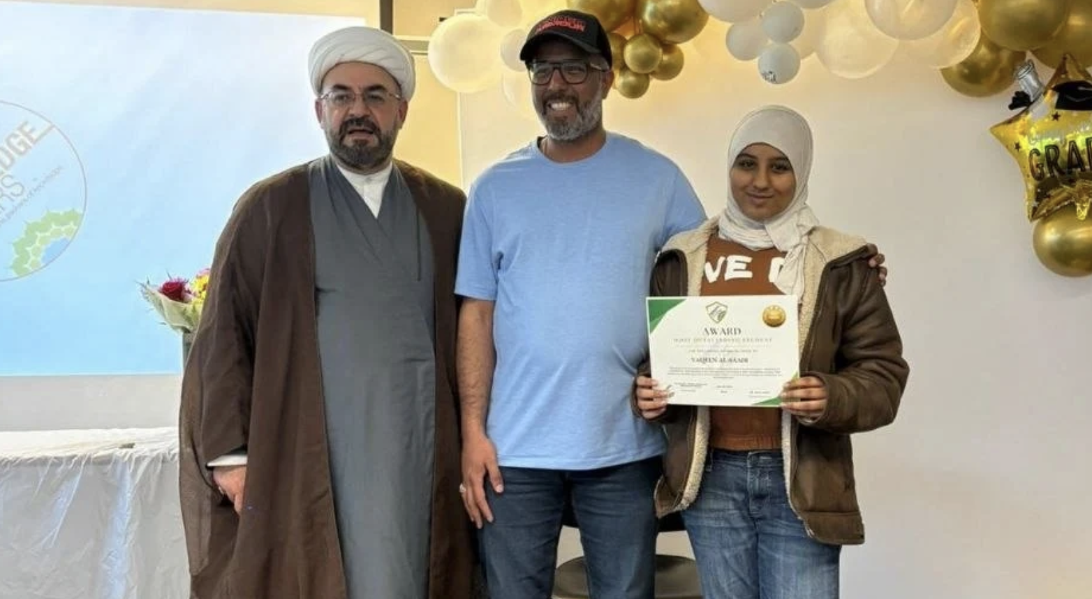 Sh. Aous Asfar with a family at an awards ceremony