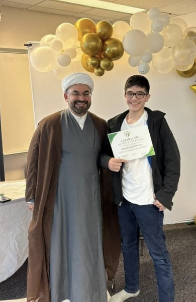 Sh. Aous Asfar presenting an award to a student