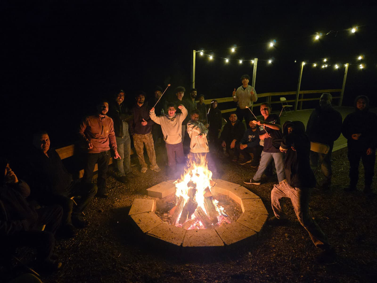 Retreat bonfire with youth and mentors at night